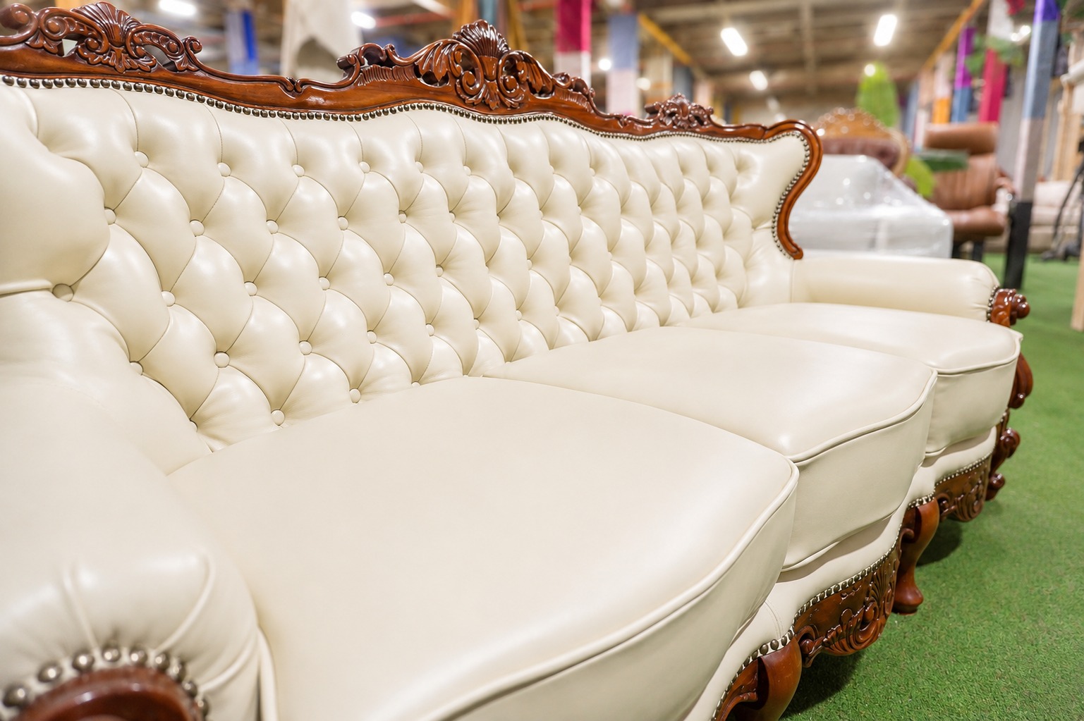 Detalle del capitoné y la talla de madera del sofá restaurado